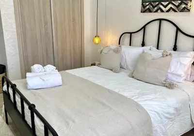 a bedroom with a large white bed with towels on it at Trésor andalous in Marrakech
