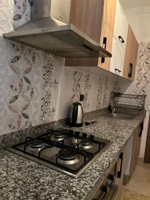 a stove top in a kitchen with a sink at Cozy Nour in Marrakech