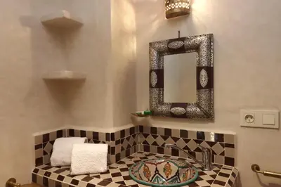 a bathroom with a sink and a mirror at Riad Dutilleul in Marrakech