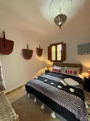 a bedroom with a large bed in a room at Riad Dutilleul in Marrakech