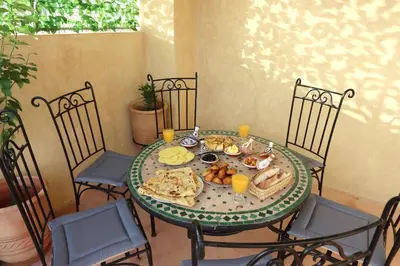 a table with a plate of food on it at Riad Blue in Marrakech