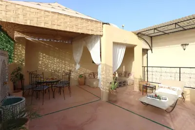 a patio with a table and chairs on a patio at Riad Blue in Marrakech