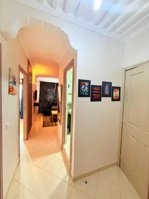 a hallway of a home with pictures on the walls at Appart FAMILY lumineux & terrasse privé in Marrakech