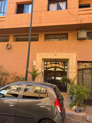 a car parked in front of a building at Appart FAMILY lumineux & terrasse privé in Marrakech