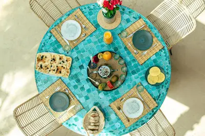 a blue table with a plate of food on it at Villa Baccarat - Piscine et Luxe in Marrakech