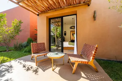 two chairs and a table on a patio at Villa Baccarat - Piscine et Luxe in Marrakech