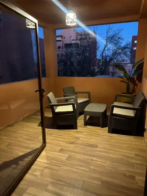 a room with chairs and a table and a mirror at Joli appartement à Gueliz in Marrakech