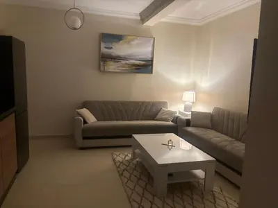 a living room with a couch and a coffee table at Joli appartement à Gueliz in Marrakech