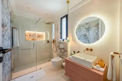 a bathroom with a shower and a toilet and a sink at White Mansion in Tameslouht