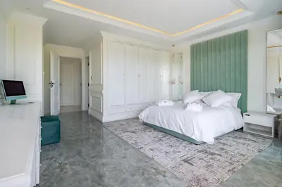a bedroom with a white bed and a television at White Mansion in Tameslouht