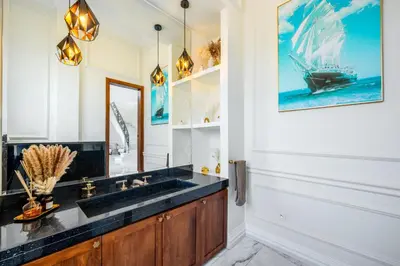 a bathroom with a sink and a boat on the wall at White Mansion in Tameslouht