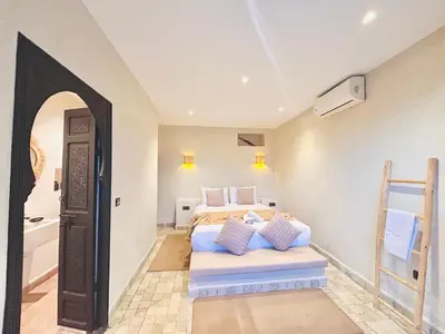 a bedroom with two beds and a bathroom at Villa piscine privée sans vis à vis, 20 min du Centre - Fibre Optique Wifi in Marrakech