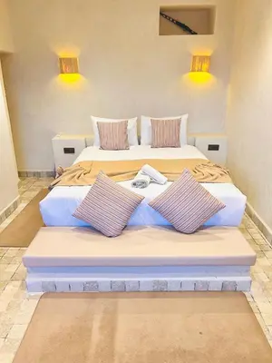 a bedroom with two beds with pillows at Villa piscine privée sans vis à vis, 20 min du Centre - Fibre Optique Wifi in Marrakech