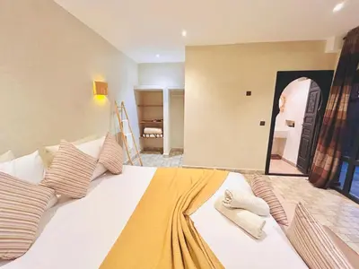 a bedroom with a large white bed with pillows at Villa piscine privée sans vis à vis, 20 min du Centre - Fibre Optique Wifi in Marrakech
