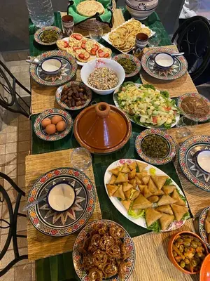 a table with many plates of food on it at Villa piscine privée sans vis à vis, 20 min du Centre - Fibre Optique Wifi in Marrakech