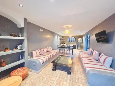 a living room with two couches and a table at Villa piscine privée sans vis à vis, 20 min du Centre - Fibre Optique Wifi in Marrakech