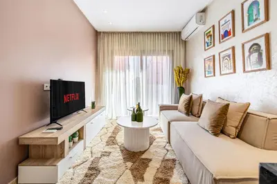 a living room with a couch and a tv at Bohochic#appartement#Gueliz in Marrakech