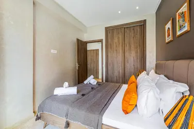 a bedroom with a bed with orange and white pillows at Bohochic#appartement#Gueliz in Marrakech