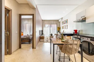 a kitchen and living room with a table and chairs at Bohochic#appartement#Gueliz in Marrakech