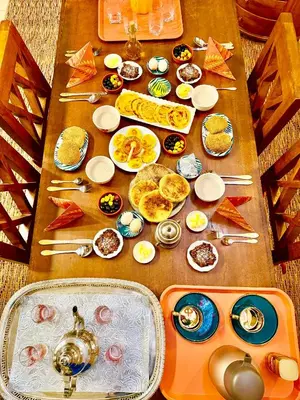 a table topped with plates of food on top at Dar Rahma- old Town Marrakech in Marrakech