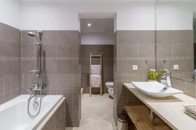 a bathroom with a sink and a tub and a toilet at Appartement de charme residence avec piscine WiFi in Marrakech