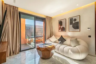 a living room with a couch and a large window at elegance et modernite au coeur de la ville in Marrakech