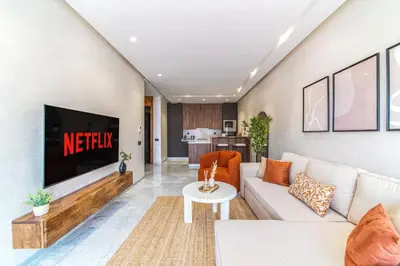 a living room with a couch and a tv at Bohemian Style in Hyper-Center - Optical Fiber in Marrakech