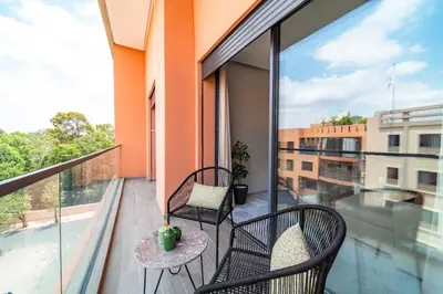 a balcony with two chairs and a table at Bohemian Style in Hyper-Center - Optical Fiber in Marrakech
