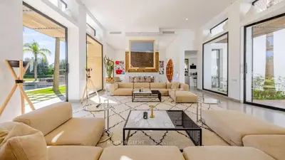 a living room with couches and a table at VilLA AYDEN in Marrakech