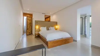 a bedroom with a large bed in a white room at VilLA AYDEN in Marrakech