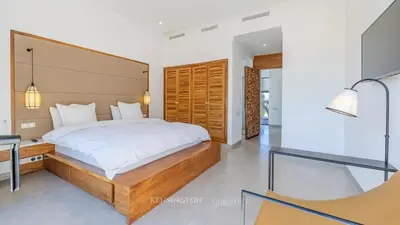 a bedroom with a large bed and a desk at VilLA AYDEN in Marrakech