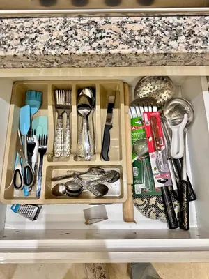 a drawer filled with utensils on top of a counter at Pearl Garden Appart 2 chambres Luxe Cosy Moderne in Marrakech