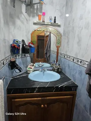 a bathroom with a sink and a mirror at cozy Apartment Near Airport in Marrakech