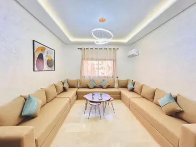 a living room with a couch and a table at New Apartment in Guéliz, Pool, Balcony & Parking in Marrakech