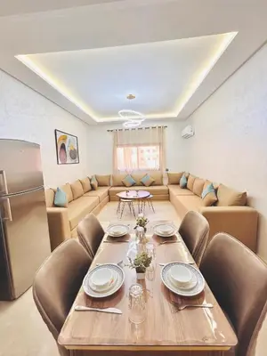 a living room with a table and a couch at New Apartment in Guéliz, Pool, Balcony & Parking in Marrakech