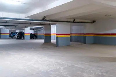 an empty parking garage with cars parked in it at New Apartment in Guéliz, Pool, Balcony & Parking in Marrakech