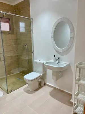 a bathroom with a shower and a toilet and a sink at Duplex chic et cosy avec piscine in Marrakech