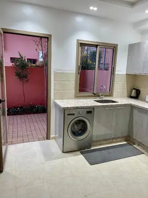 a kitchen with a washing machine and a sink at Duplex chic et cosy avec piscine in Marrakech