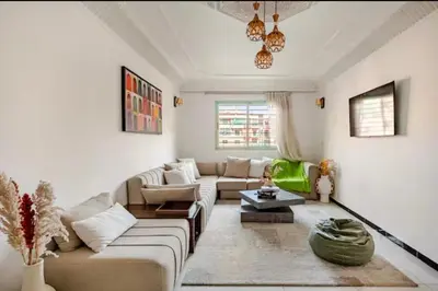 a living room with a couch and a table at Appart hôtel avec piscine in Marrakech