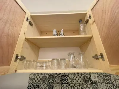 a cupboard with a bunch of glass items on it at Neuf appartement a marrakech in Marrakech
