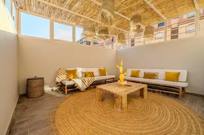 a living room with two couches and a table at Grand appartement deux terrasses in Marrakech