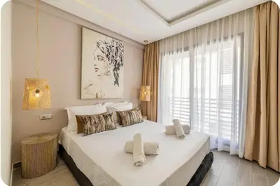 a bedroom with a large white bed and a window at Appartement en hyper Centre in Marrakech