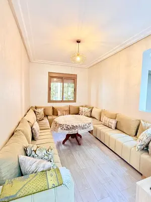 a living room with a large couch and a table at N7 Confort Cosy Près De Gueliz in Marrakech