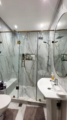 a bathroom with a shower and a sink and a toilet at Le Confortable a 15mn de L'aéroport interdit au couples non marié in Marrakech