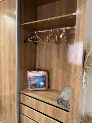 a bag sitting on a wooden shelf in a closet at Le Confortable a 15mn de L'aéroport interdit au couples non marié in Marrakech