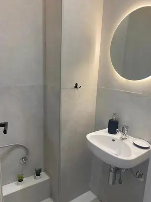 a white bathroom with a sink and a mirror at Centre ville Gueliz Plaza Marrakech in Marrakech