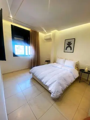 a bedroom with a white bed and a window at Centre ville Gueliz Plaza Marrakech in Marrakech