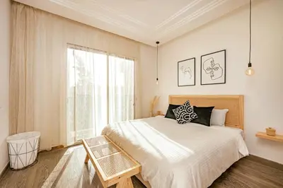 a bedroom with a large bed and a window at Modern Oasis with Waterpark in Marrakech