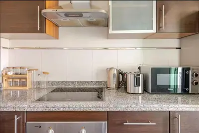 a kitchen with a counter top with a microwave at Sojori Majorelle piscine et parking in Marrakech