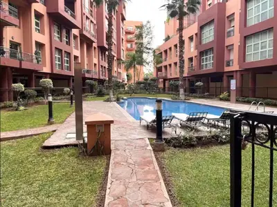 a courtyard with a swimming pool in a building at Sojori Majorelle piscine et parking in Marrakech